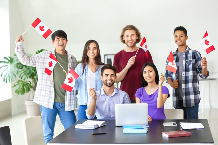 Group of students with Canadian flags in classroom